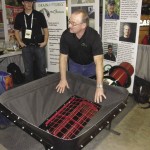 Man displaying his grain auger invention.
