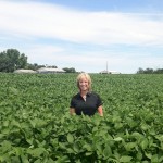Woman standing in a field of soybeans.