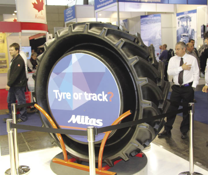 Tractor tire on display at trade show.