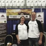 A man and woman at trade show booth.