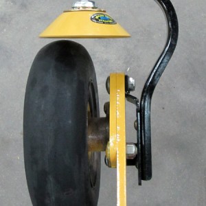 Mud scraper cup mounted above a wheel.