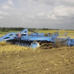 Disc harrow in farmer's field.