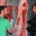 Chef Nathan Guggenheimer and Melanie in the Pine View Farms store meat cooler, selecting a cut of pork.