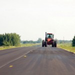 Slow moving vechicle — SMV — on the road. Notice the triangular sign on the back left.