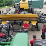 Owen Kinch, field research manager, explains the features of the SeedMaster metering system to farmers attending a demonstration day at the company’s research farm in June.