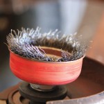 The wire bristles on this angle grinder attachment stripped off during use and were sent flying back toward the operator, which emphasized the need for constant eye protection in the workshop.