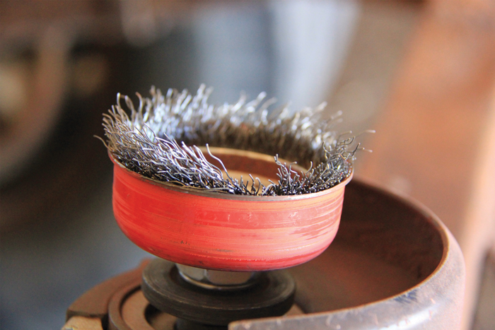 The wire bristles on this angle grinder attachment stripped off during use and were sent flying back toward the operator, which emphasized the need for constant eye protection in the workshop.
