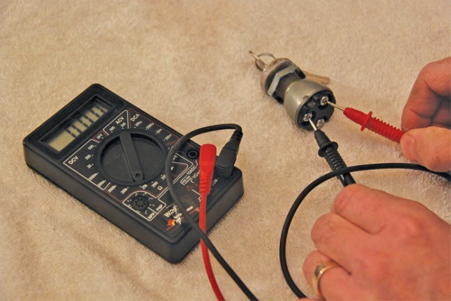 When the meter leads are connected to the posts of this ignition switch with the key turned on, current is able to flow back through the other lead and the readout changes to indicate how much resistance there is. The 000 readout indicates a complete (closed) circuit with no resistance.