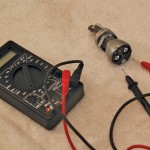With the multimeter’s dial set to (Ohms), its internal battery sends a small amount of voltage through one lead. If the leads are neither connected to each other nor touching a closed wiring circuit current won’t flow, and the digital readout will indicate an open loop, a “1” on this meter.