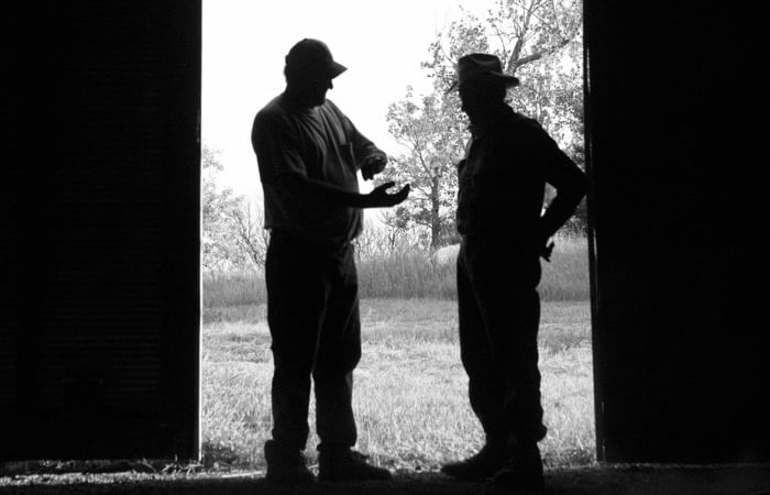 Men in doorway of barn