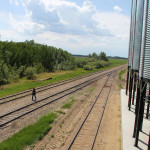 Western Producer reporter Karen Briere walks the tracks at Torch River Rail's producer car loading facility in Choiceland, Sask.
