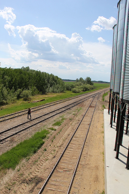 Western Producer reporter Karen Briere walks the tracks at Torch River Rail's producer car loading facility in Choiceland, Sask.