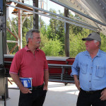 Kevin Hursh and Ron Shymanski, chair of Torch River, chatting during Sask Farm Writers' Federation media tour at Torch River Rail in Choiceland, Sask.