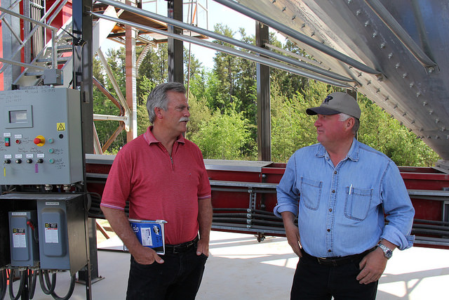 Kevin Hursh and Ron Shymanski, chair of Torch River, chatting during Sask Farm Writers' Federation media tour at Torch River Rail in Choiceland, Sask.