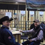Phil Birnie of WRAZ Red Angus and Garnet Yewsiuk of V6 Livestock chatting over coffee in the JJL Livestock Booth on Thursday morning.