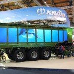 Adding bling like these synchronized television screens on the side of a Krone silage wagon help grab attention from passers-by.