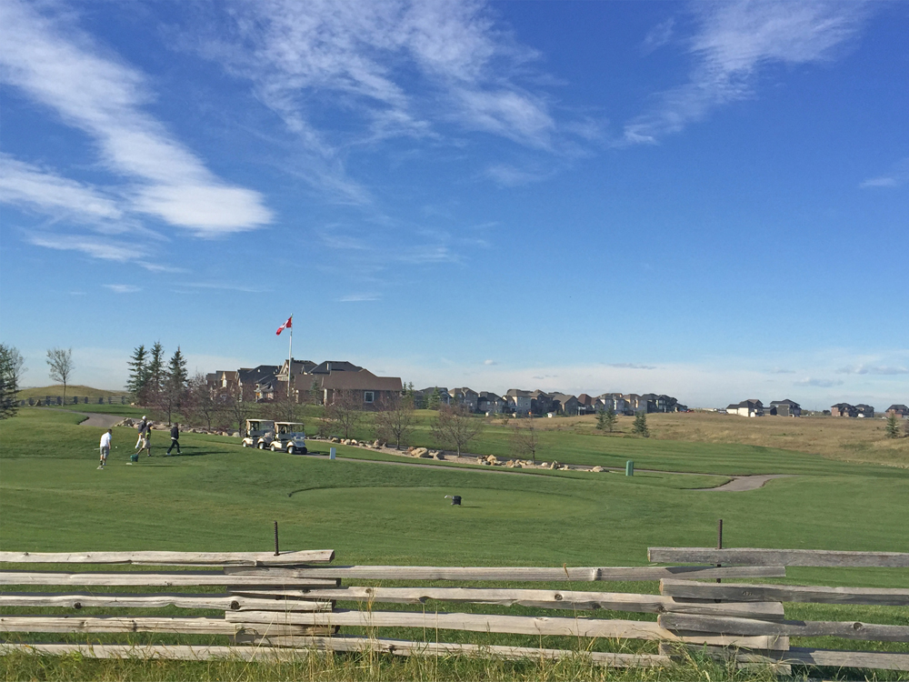 Golfers teeing up on the 18-hole course that neighbours the Lakes of Muirfield housing development.