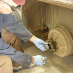 To get the drums off, pry off the dust cap and remove the axle nut.
