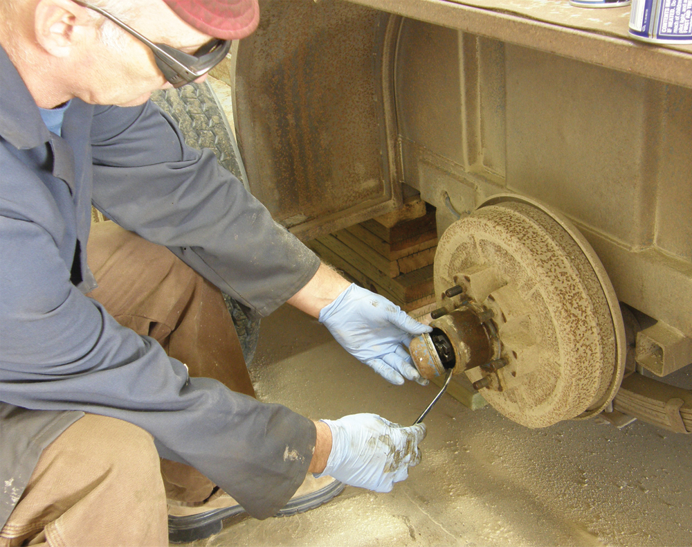 To get the drums off, pry off the dust cap and remove the axle nut.