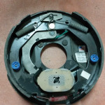 The four wear indicator holes are visible on the magnet in this new backing plate assembly. Because of the way electric brakes work, there is a left and right side assembly. Don’t mix them up.