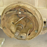 The wear indicators are no longer visible on this magnet, meaning it is ready for replacement. Remember, brake shoes on old equipment may be made of asbestos. Don’t use compressed air to blow out debris. Use only liquid brake cleaner and wear a dust mask for safety.