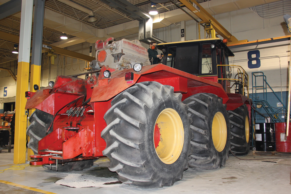 Workers continue the teardown process. 