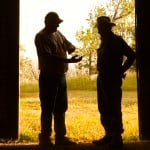 Men in doorway of barn