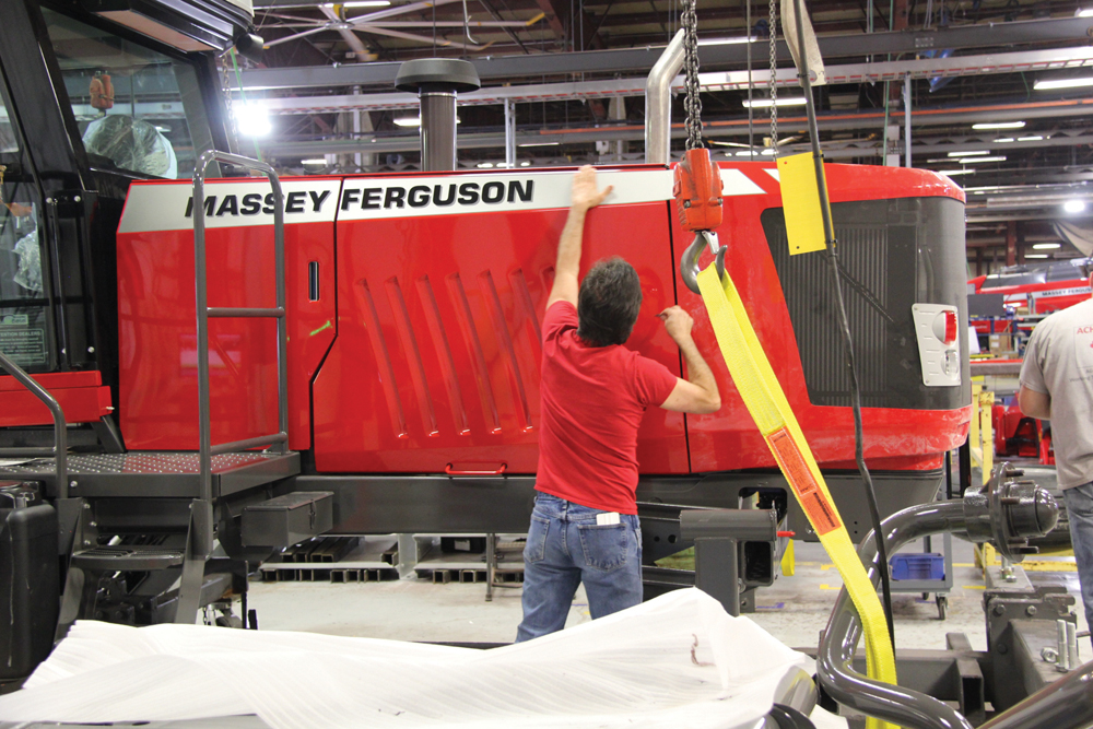 After testing, all panels are in place and a worker applies decals. 