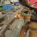 Clamped firmly in place, the two pieces of steel forming this 90 degree outside joint are positioned properly, allowing for excellent weld penetration.