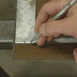 Using a scribe to mark cut lines allows for transferring precise measurements and exactly positioning the torch guide.