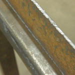 The plasma cutter leaves a striated edge on the steel similar to that of an acetylene torch. It requires some dressing with a grinder to create a finished face.