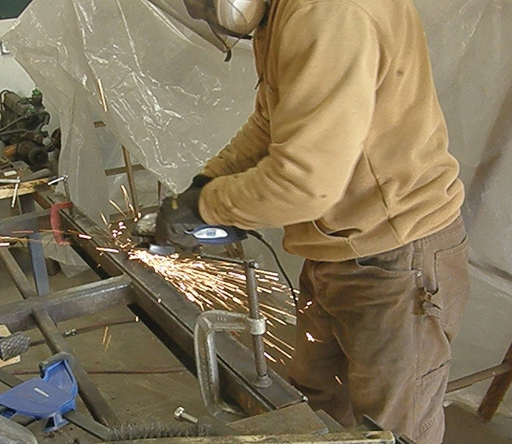 An angle grinder is used to smoothen out the weld bead and make the bumper look like one seamless piece.