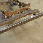 Fitted into place with the original bent and broken part behind it, the replacement bumper looks exactly like the original once did. The only thing left to do is drill holes for the mounting bolts.