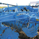Harrow tines between the disc rows help break up and mix surface material.
