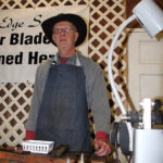 Roy Herbach of Moose Jaw, Sask., sharpens blades on the Canadian Western Agribition show grounds.