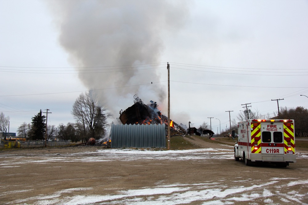 Local volunteer firefighters keep watch over the fire.