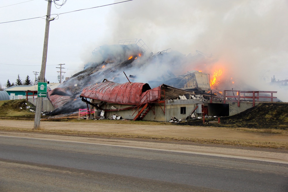 The tail end of a semi is visible as the grain elevator smoulders in Turtleford.