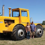 Glenn and Bob Richards Jr. of Southern Ontario  stand beside their tractor.