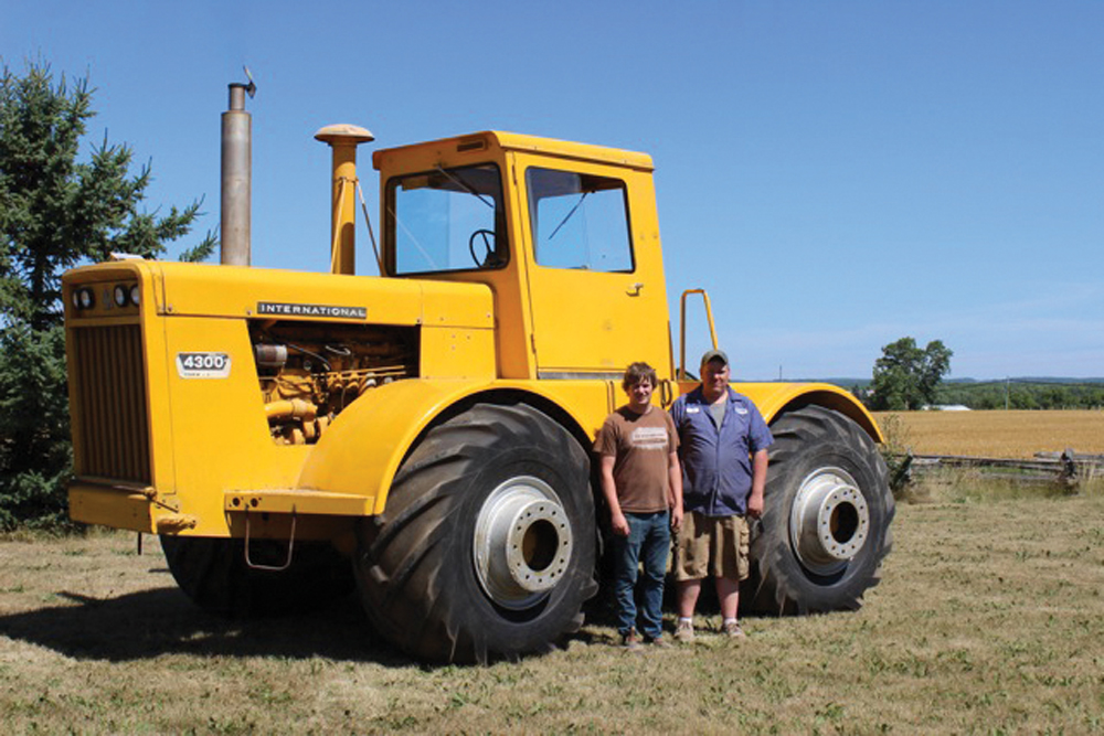 Glenn and Bob Richards Jr. of Southern Ontario  stand beside their tractor.