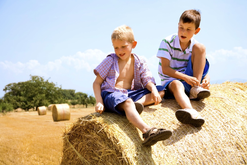 Boys on hay bale