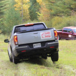 The Honda Ridgeline gets a good test of its suspension in this grassy field.