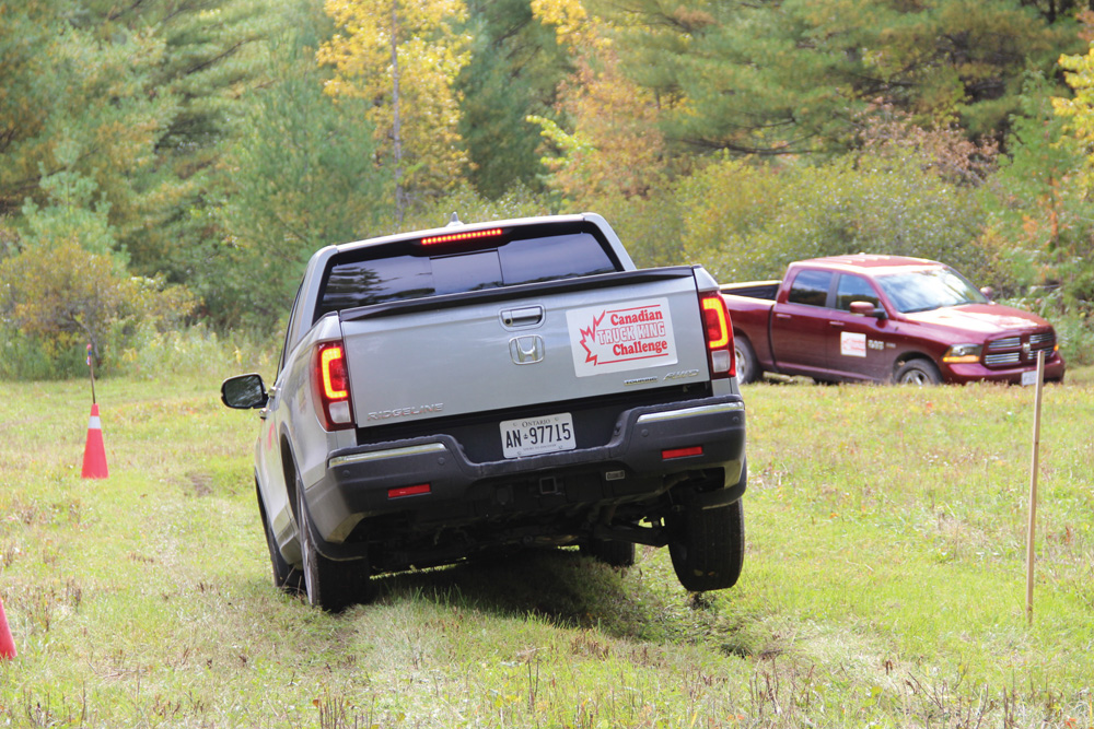 The Honda Ridgeline gets a good test of its suspension in this grassy field.