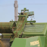 After passing through the forming rollers, pellets move through this slotted drum. Incomplete pellets fall back into the material flow to be reformed, while finished pellets are dropped onto the conveyor for movement to the storage hopper.