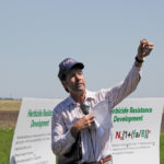 Hugh Beckie was on hand during Nufarm’s field day at Ag-Quest’s Saskatoon location. Beckie is holding a GPS collar that researchers can attach to kochia plants to track how the weed disperses seeds as it tumbles across the prairie.
