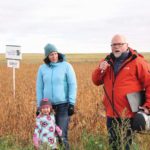 Jennifer Bogdan and Gary Sollid of Crop Production Services talk soybean agronomy at the Ag in Motion site north of Langham. Also pictured is Jennifer’s three-year-old daughter, Katla, who enjoys long walks through soybean fields.