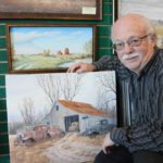 Dan Reid with some of his paintings.