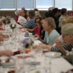 Community members of all ages gather together to enjoy local food at a previous Slow Food Saskatoon event.