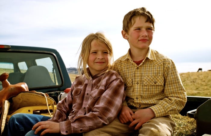 Siblings in back of truck