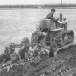A TD6 pulls a plow through clay soil.