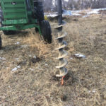When a crowbar isn’t enough on frozen ground, a powered auger
can get a hole started.
